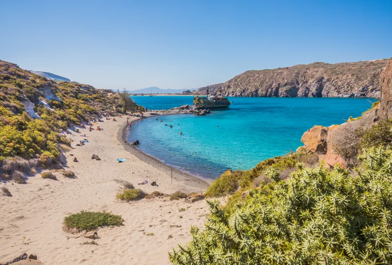 Swimmers in a warm sandy Mediterranean cove